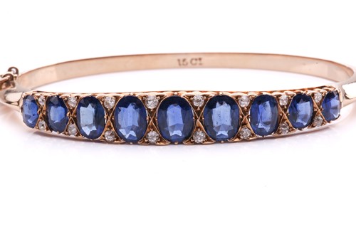 Lot 150 - A sapphire and diamond hinged bangle, the...
