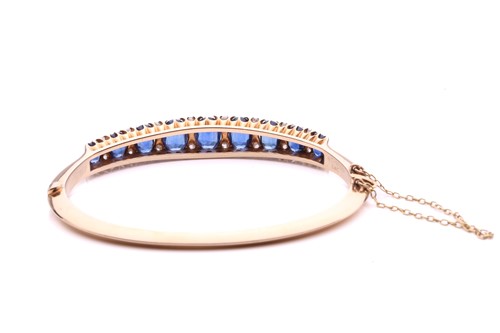 Lot 150 - A sapphire and diamond hinged bangle, the...