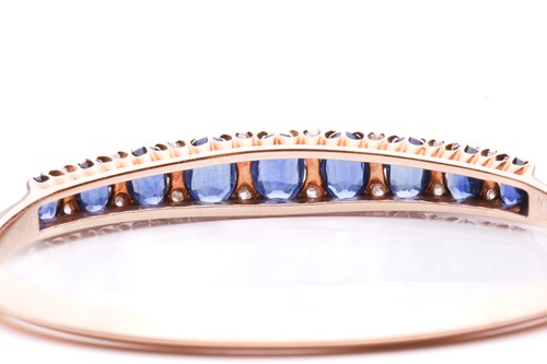 Lot 150 - A sapphire and diamond hinged bangle, the...