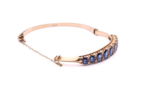 Lot 150 - A sapphire and diamond hinged bangle, the...