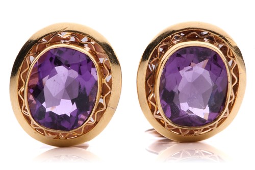 Lot 54 - A pair of amethyst earrings, each consisting...