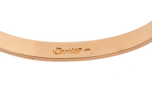Lot 199 - Cartier - a 'LOVE' bangle, composed of two...