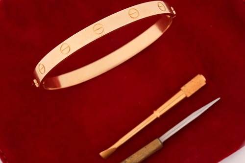 Lot 199 - Cartier - a 'LOVE' bangle, composed of two...