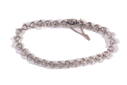 Lot 201 - A diamond tennis bracelet in platinum, set...