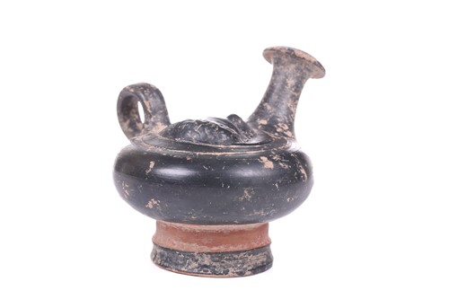 Lot 226 - A South Italian black glaze Guttus, likely...
