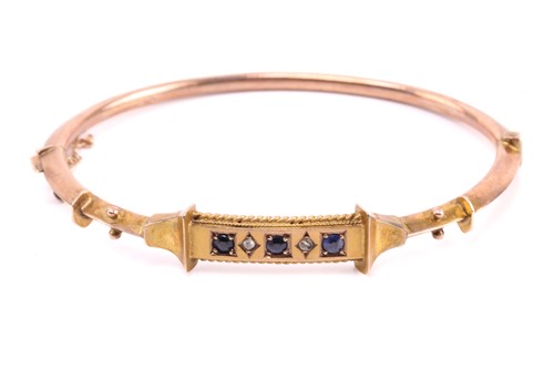 Lot 44 - A Victorian hinged bracelet set with blue...