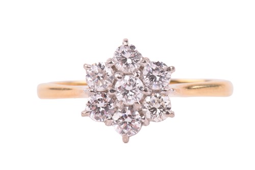 Lot 244 - A diamond daisy cluster ring set with round...