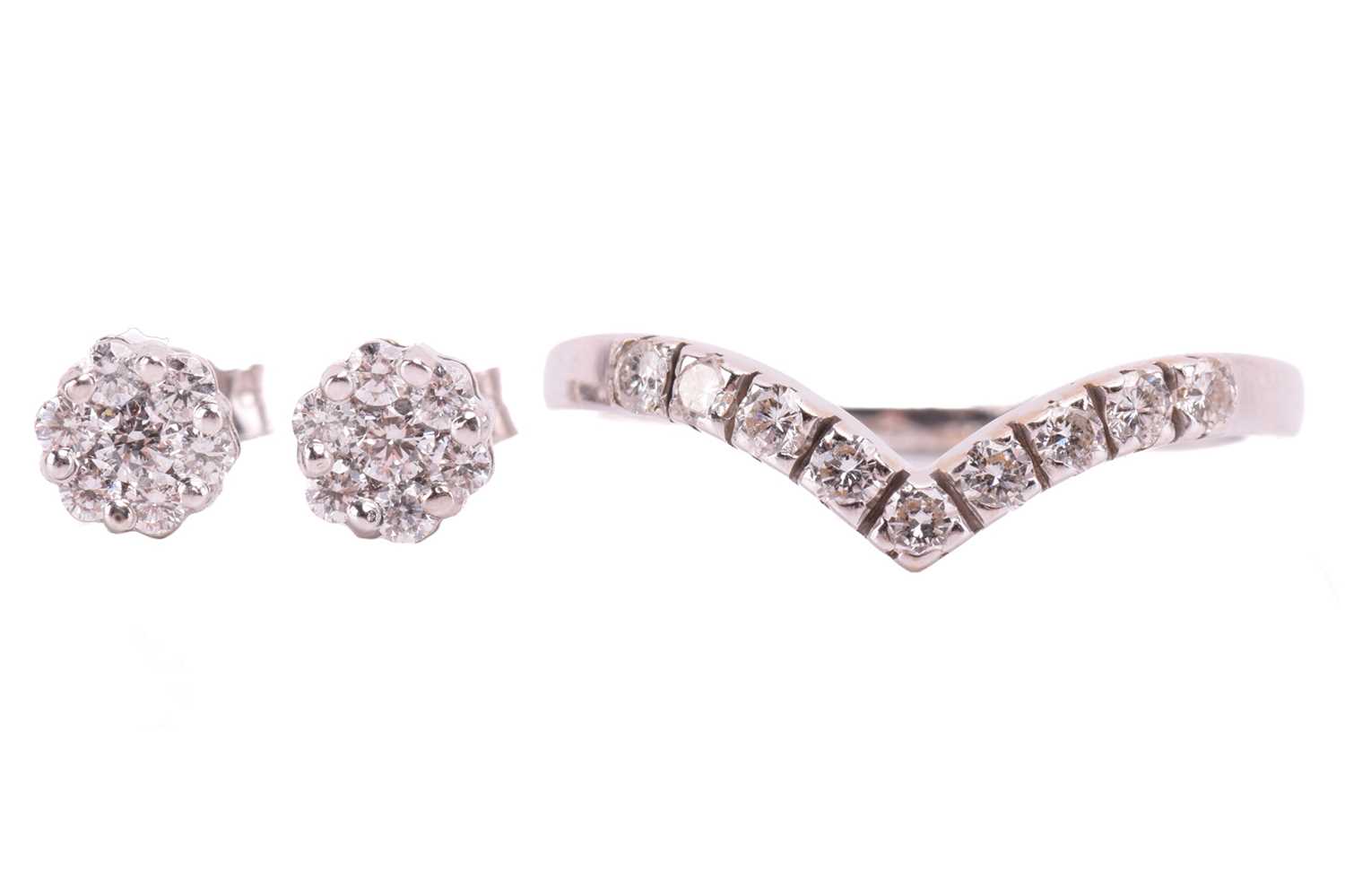Lot 125 - A diamond ring and earrings; the ring in a...