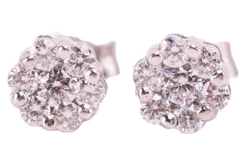 Lot 125 - A diamond ring and earrings; the ring in a...