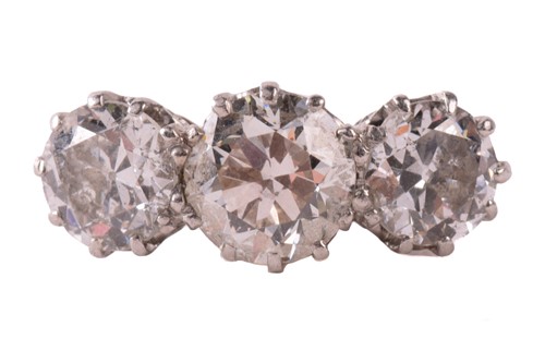 Lot 59 - A three-stone diamond half-hoop ring,...