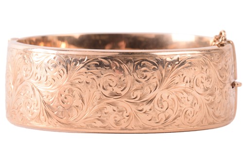 Lot 120 - A 9ct yellow gold hinged bangle, half of the...