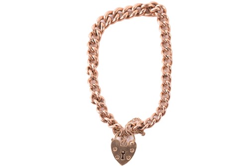 Lot 236 - A 9ct gold curb link bracelet with heart...