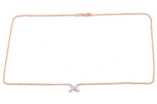Lot 34 - A diamond kiss pendant, set with round...