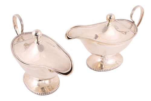 Lot 518 - A pair of George V silver sauceboats with...