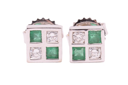 Lot 22 - A pair of emerald and diamond stud earrings in...