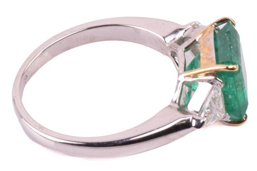 Lot 6 - A vivid emerald and diamond three-stone ring,...