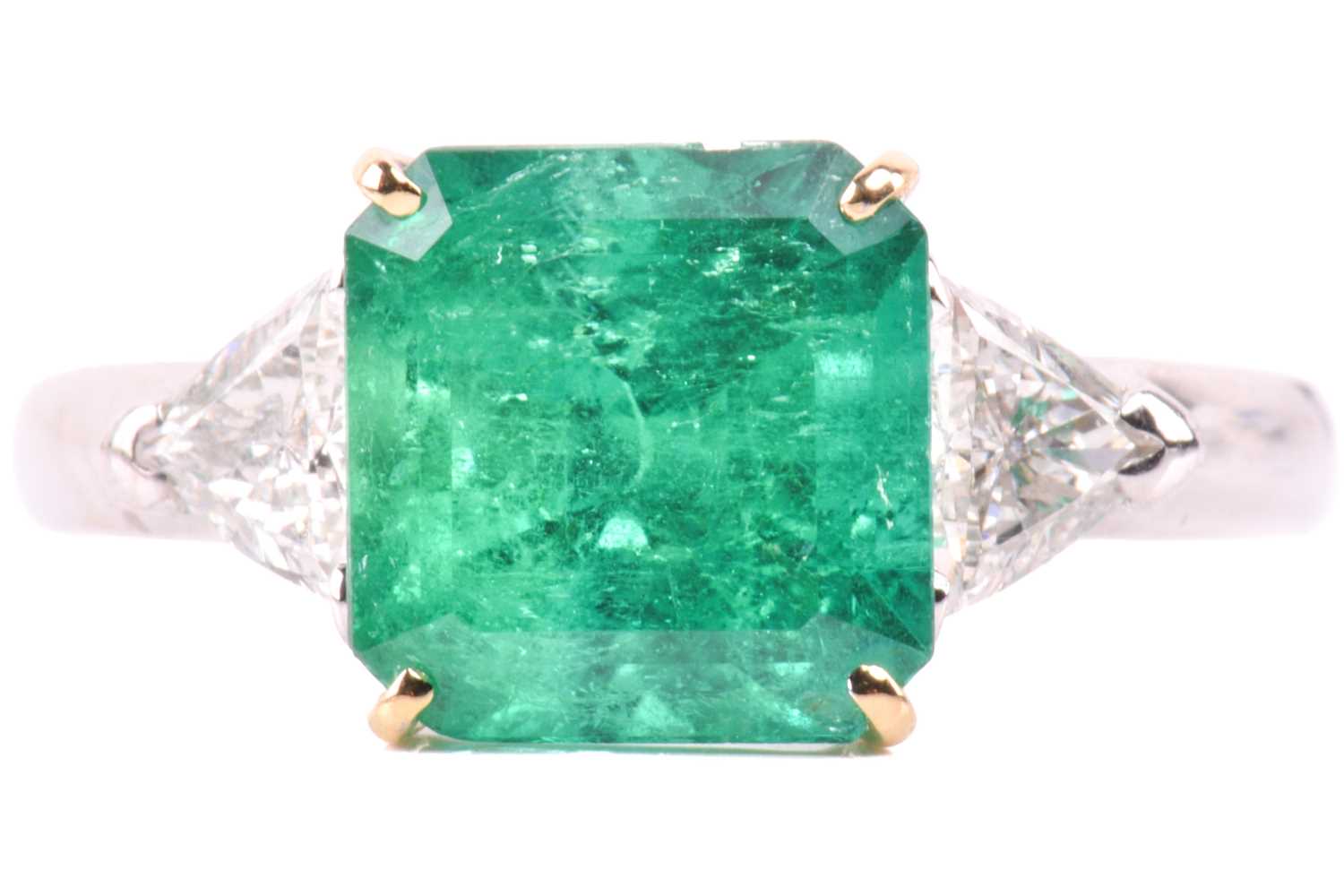 Lot 6 - A vivid emerald and diamond three-stone ring,...