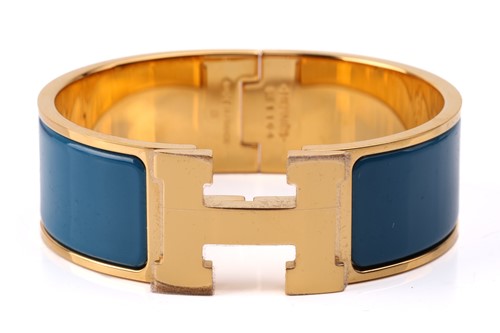 Lot 70 - Hermès - A wide 'Clic H' bracelet with teal...