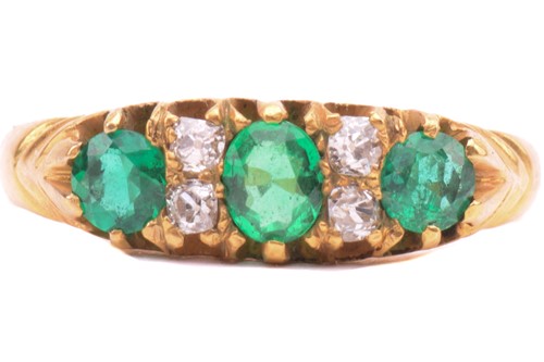 Lot 267 - An emerald and diamond half hoop ring, set...