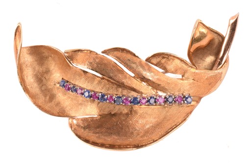 Lot 178 - A ruby and sapphire feather brooch in textured...