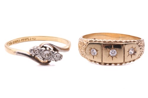 Lot 95 - A diamond three stone cross over ring set with...