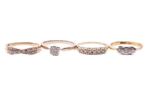 Lot 24 - Four diamond rings; a three stone ring with a...