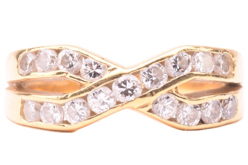 Lot 41 - A diamond cross over ring, set with two rows...