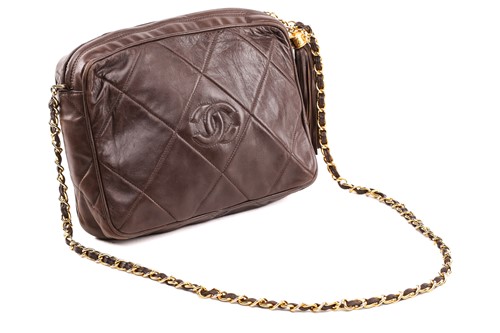 Lot 27 - Chanel - a camera bag in brown quilted...