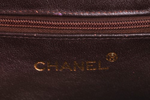 Lot 27 - Chanel - a camera bag in brown quilted...