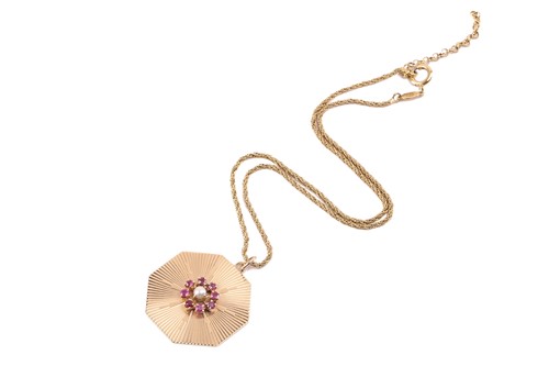 Lot 257 - A ruby and pearl cluster pendant on chain, the...