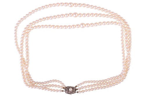 Lot 32 - Mikimoto - a three-strand cultured pearl...