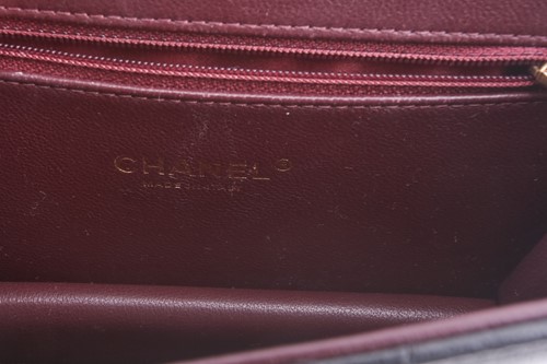 Lot 48 - Chanel - a mini Beauty Lock flap bag in black...