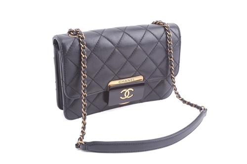 Lot 48 - Chanel - a mini Beauty Lock flap bag in black...