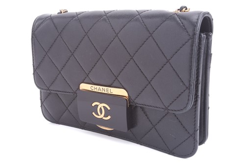 Lot 48 - Chanel - a mini Beauty Lock flap bag in black...