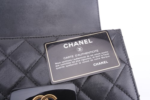 Lot 48 - Chanel - a mini Beauty Lock flap bag in black...