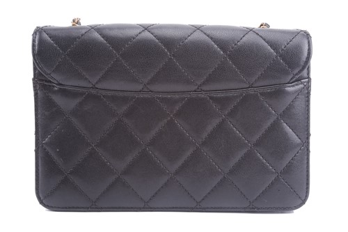 Lot 48 - Chanel - a mini Beauty Lock flap bag in black...
