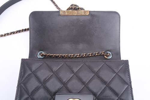 Lot 48 - Chanel - a mini Beauty Lock flap bag in black...
