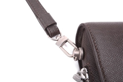 Lot 22 - Louis Vuitton - a clutch bag in dark brown...