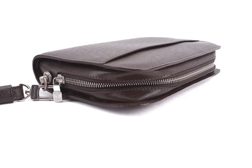 Lot 22 - Louis Vuitton - a clutch bag in dark brown...