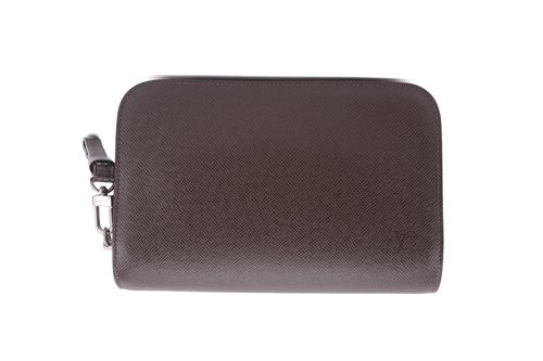 Lot 22 - Louis Vuitton - a clutch bag in dark brown...