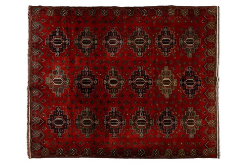 Lot 217 - A large dark red ground Turkomen-style carpet,...