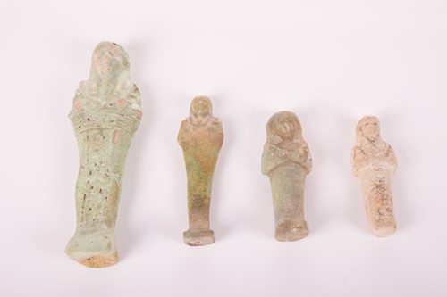 Lot 242 - An Egyptian faience shabti with a mottled...