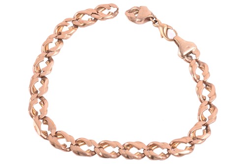 Lot 235 - A curb link bracelet in 9ct yellow gold,...