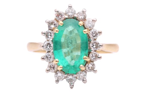 Lot 51 - An emerald and diamond cluster ring, the oval...