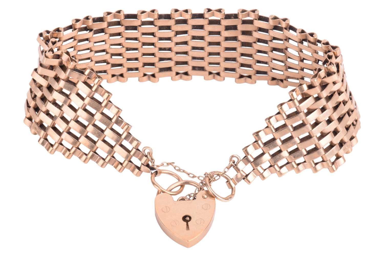 Lot 111 - A tapering gate bracelet with a heart-shaped...
