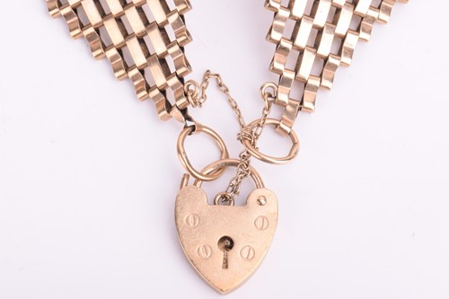 Lot 111 - A tapering gate bracelet with a heart-shaped...