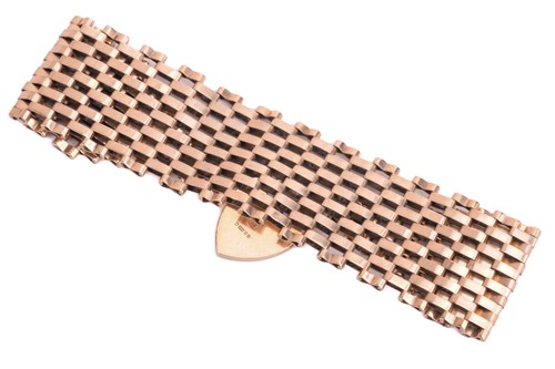 Lot 111 - A tapering gate bracelet with a heart-shaped...