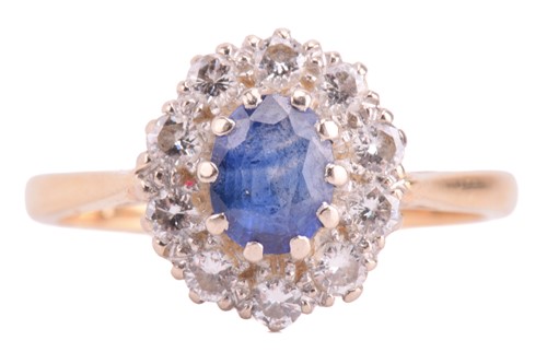 Lot 8 - A sapphire and diamond halo ring in 18ct gold,...