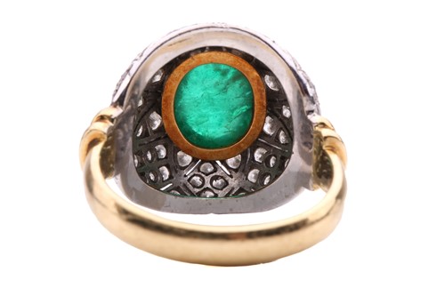 Lot 180 - An emerald and diamond bombé ring, featuring...