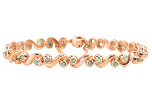 Lot 98 - An emerald and diamond line bracelet, composed...